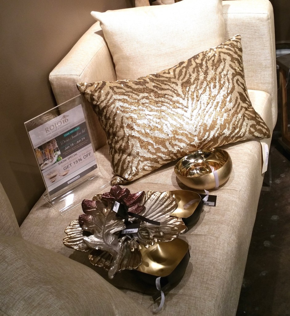 Details of gold home accents and pillow by ARTS award-winning team, Rojo16.