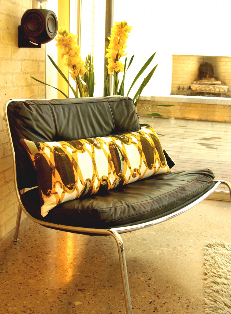 Mid-century chain link pillow backed with chocolate faux ostrich. Modern Home Tour Austin. Photography by Gregg Cestaro.