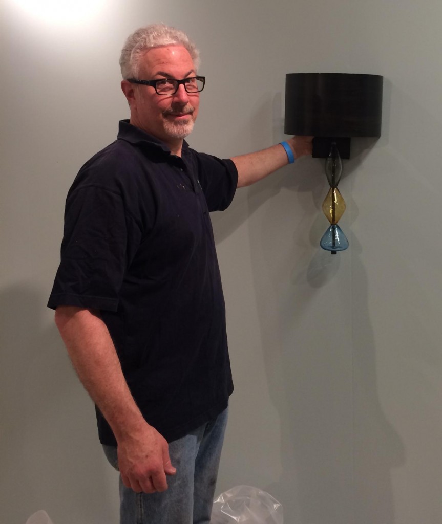 John Strauss, of CMJSCreativ hanging one of their NEW featured Koncept lighting sconces at High Point. Photography by CMJSCreativ.