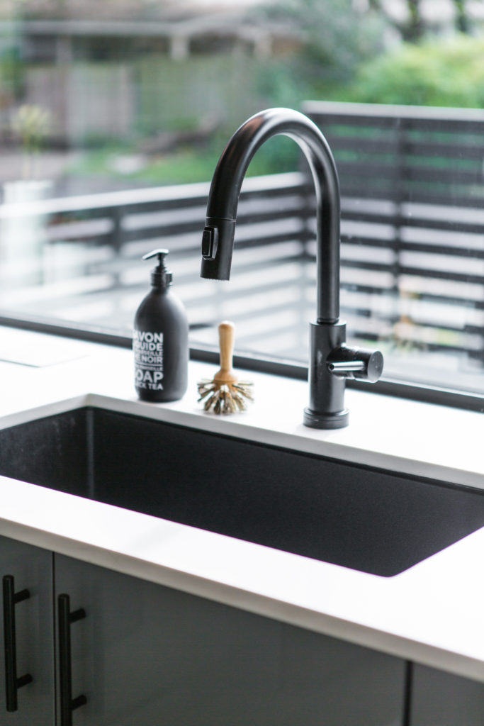 On trend black faucet in the kitchen of the Newcastle Home. More on The Pillow Goddess Blog!
