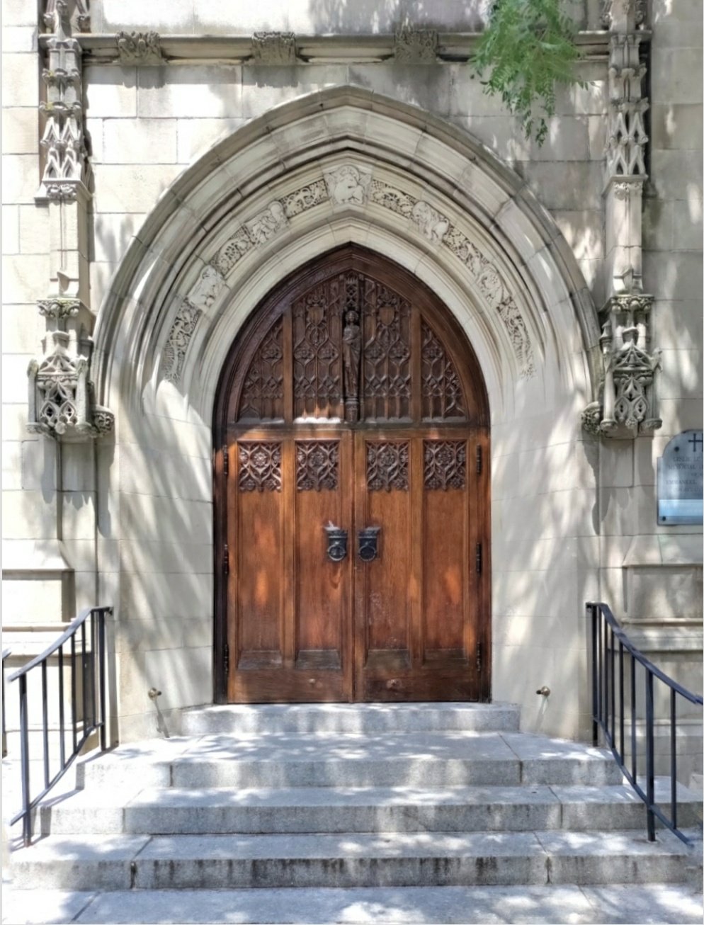 Architectural detail of a church front door and carved facade.