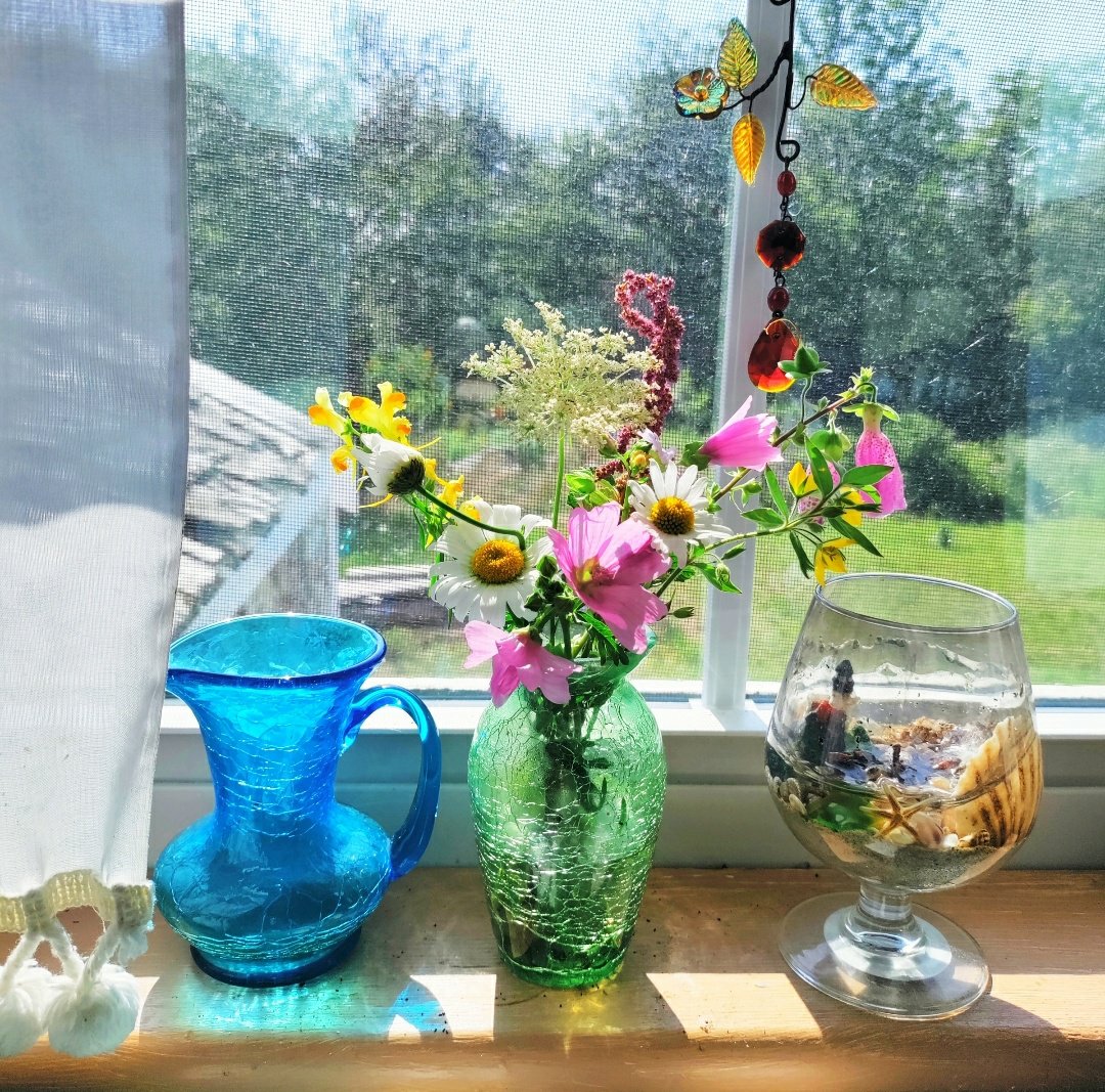 wildflowers on a shelf with vintage glassware, Deer Isle, Maine